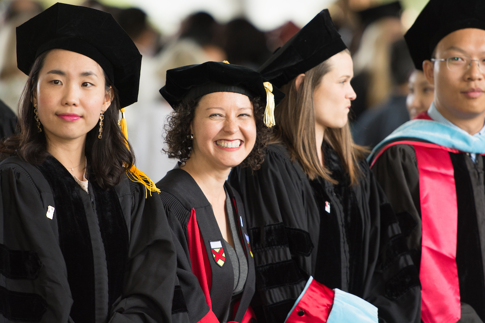 Photo of graduating students carrying their stoles.