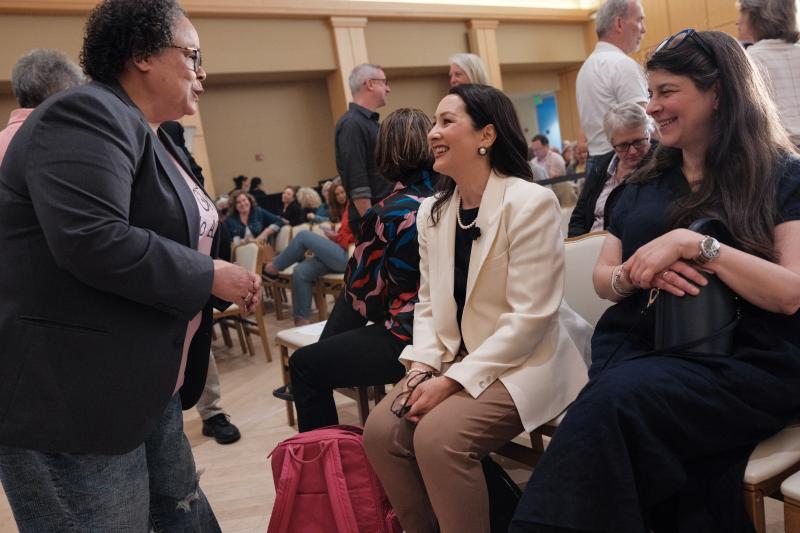 Christine Min Wotipka speaking with a guest